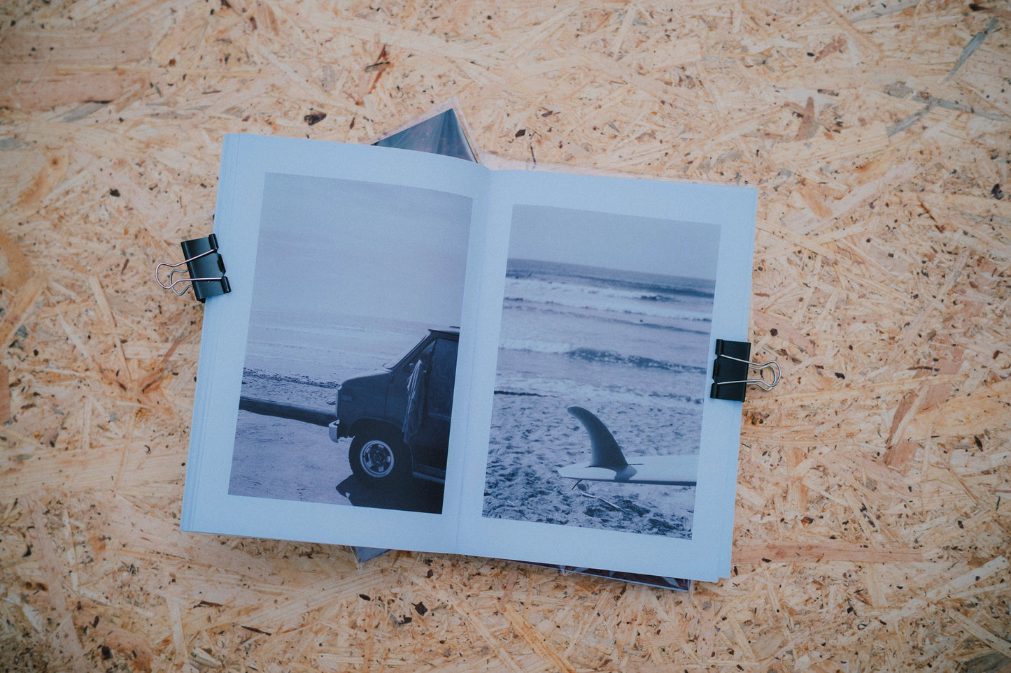 Open book with black and white photos of a truck on a textured surface