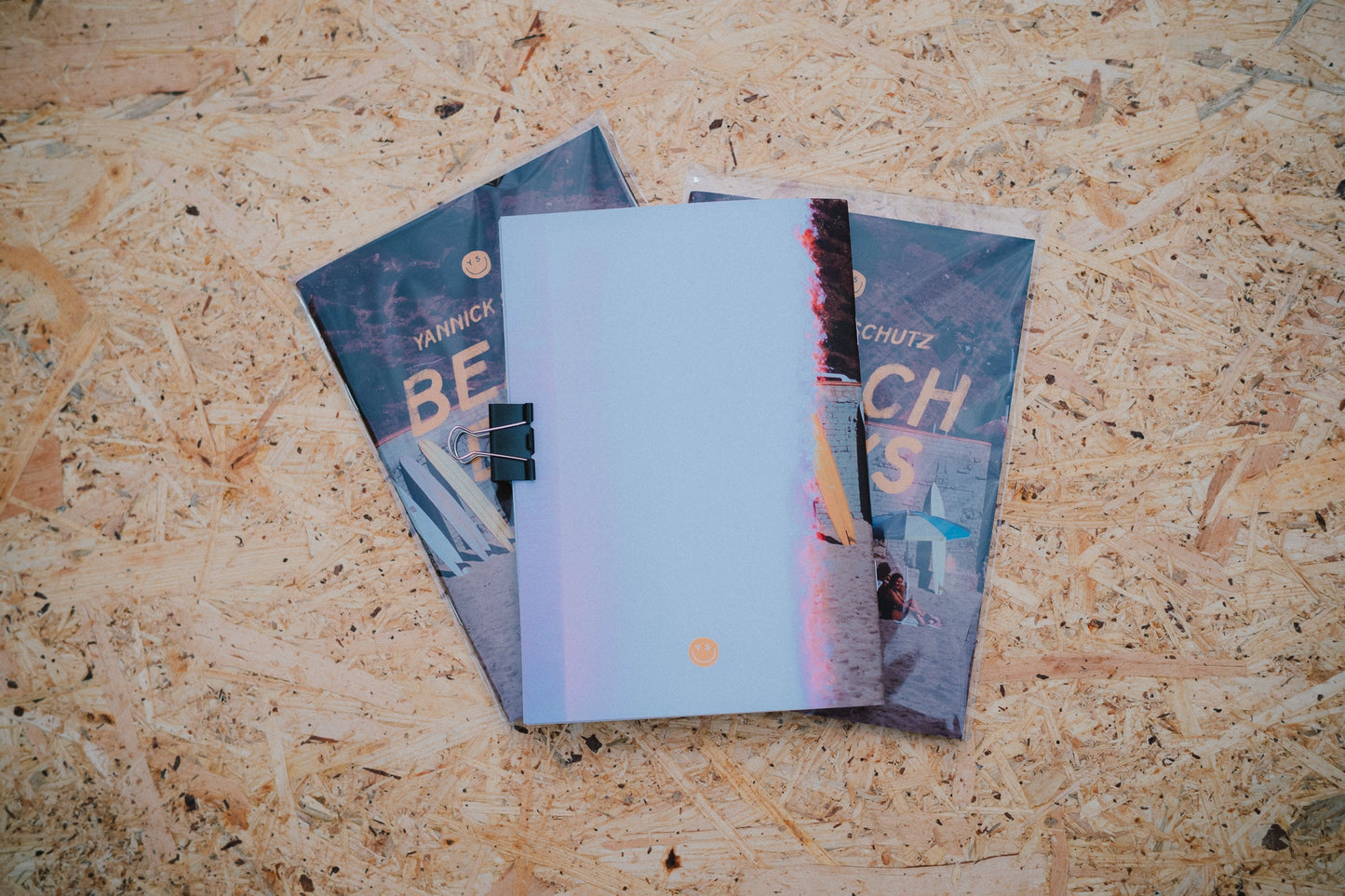 Three books stacked on a wooden surface
